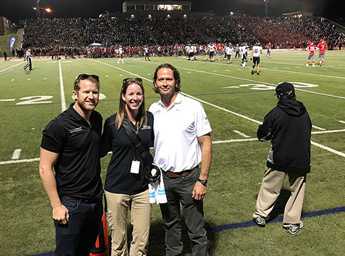 Dr Justin Newman on the sideline of a high school football game.